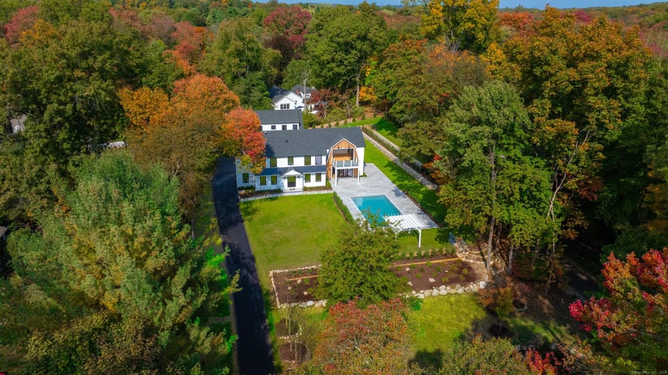 Aerial view of a luxury Fairfield County, Connecticut estate with pool and fall foliage — the kind of highly appreciated real estate a Deferred Sales Trust can help you sell while deferring capital gains tax